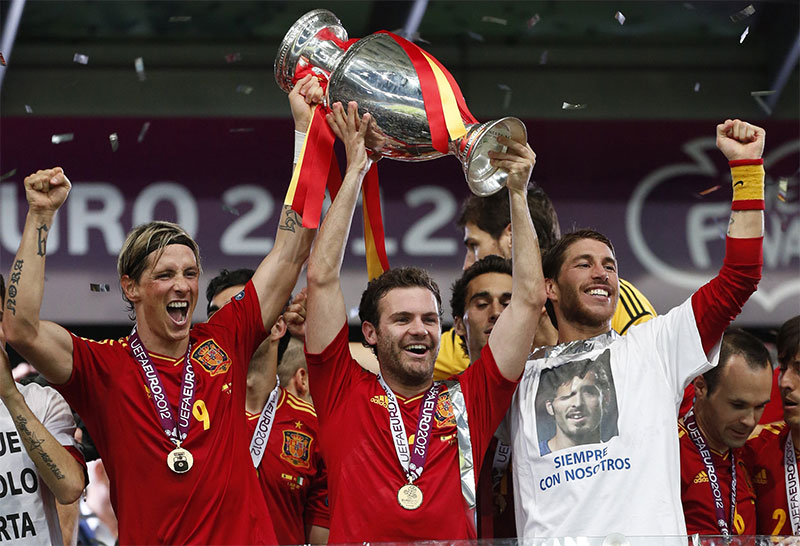 Spanish footballers Fernando Torres, Juan Mata, and Sergio Ramos celebrating winning the UEFA European Championship in 2012