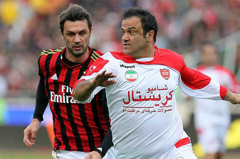 Paolo Maldini marking a player during a friendly match.