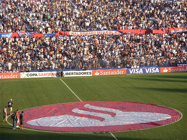 The logo of Banco Santander displayed on the field of Estadio Gran Parque Central, 2010